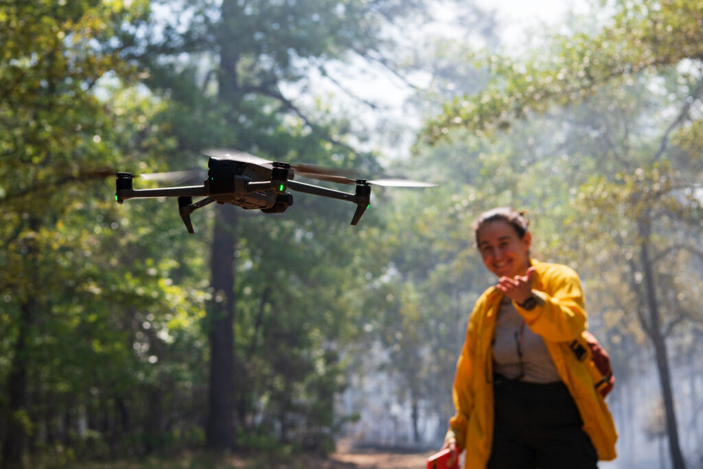 Postdoctoral Jones Center researcher Nicole Zampieri observes a drone flight during a prescribed fire