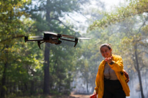 Postdoctoral Jones Center researcher Nicole Zampieri observes a drone flight during a prescribed fire